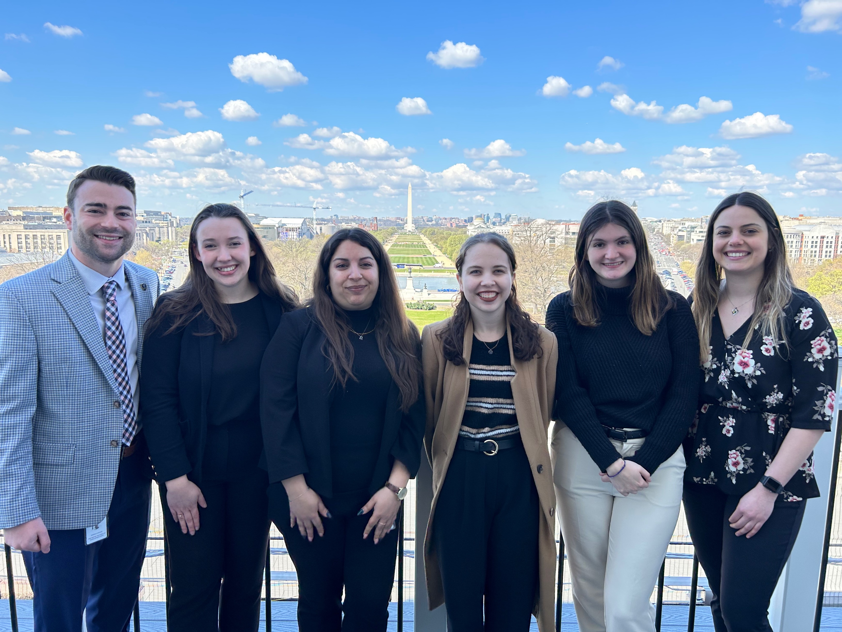 Spring 2023 interns and internship coordinators on the Speaker's Balcony of the US Capitol while on a tour with the United States Capitol Police. 