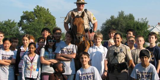 Mounted patrol officer with children.