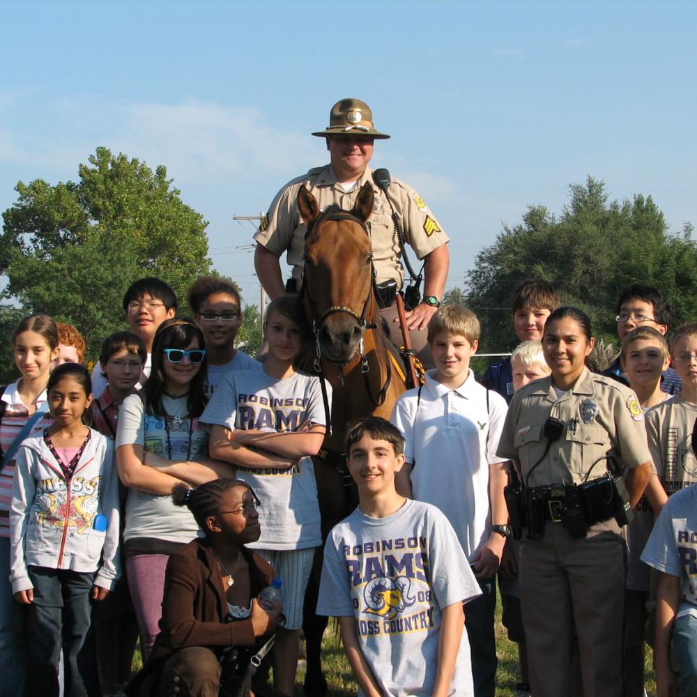 Officer on horse with smiling children